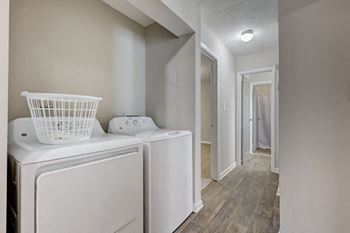 A white washer and dryer in a laundry room.